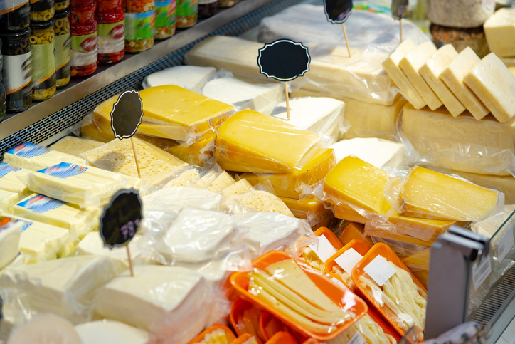 Assortment of appetizer cheese at food shop stand close up