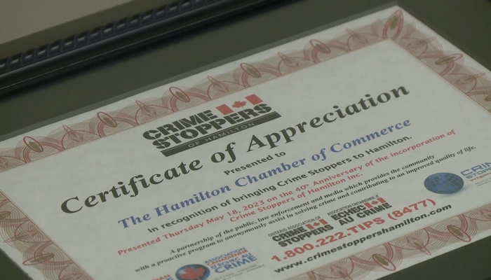 Crime Stoppers presents plaque to Hamilton Chamber of Commerce to celebrate 40 years