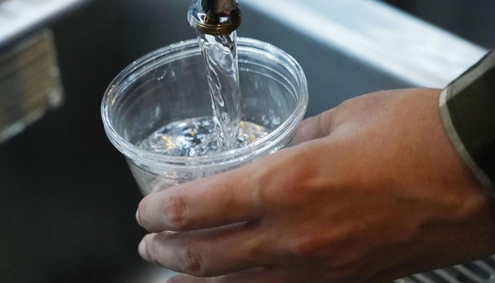 A cup of water is drawn from a faucet in Jackson, Miss., Thursday, Sept. 1, 2022.