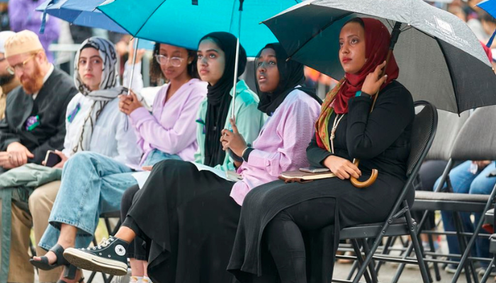 Hundreds gather on a rainy evening at a vigil for the Afzaal family in London, Ont., Monday, June 6, 2022.