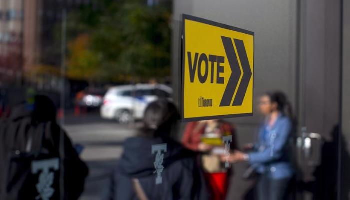 Voters line up outside a voting station to cast their ballot in the Toronto's municipal election in Toronto on Monday, October 22, 2018.