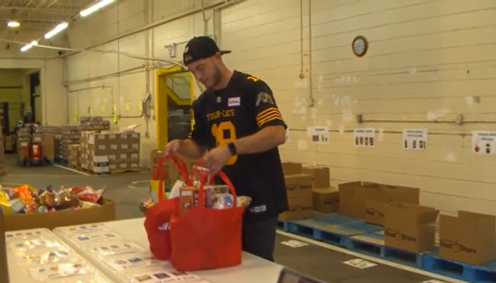 Ticats quarterback helps promote Purolator Tackle Hunger Event