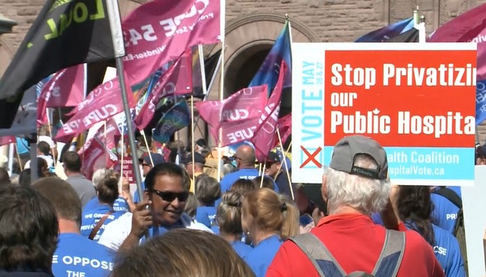 Protesters against healthcare privatization gather at Queen’s Park