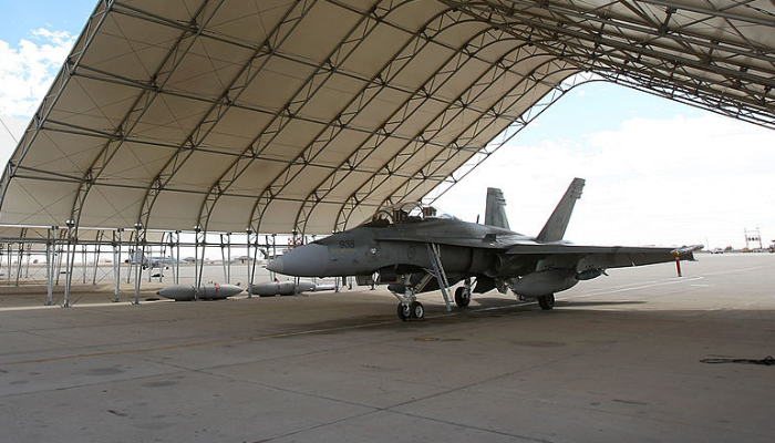 CF-18 Hornet fighter jets belonging to the Canadian 410 'Couger' Squadron are seen under shelters on the tarmac at Naval Air Facility (NAF) El Centro on November 4, 2009 near El Centro, California.