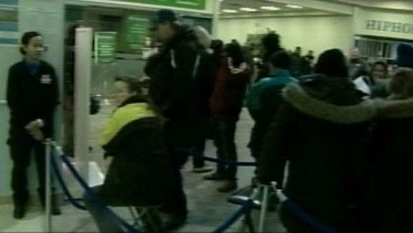 Residents line up for grocery gift cards at an Ontario Works office in Toronto, January 3, 2014