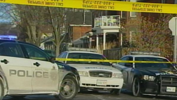 Police guard a home where a break and enter happened; Hamilton, March 6, 2014