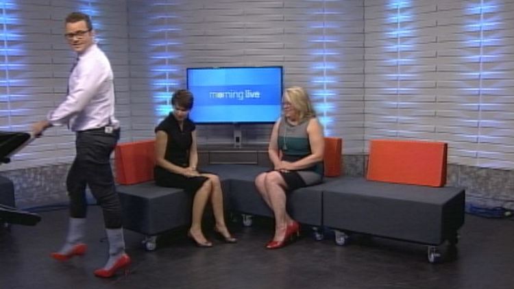 Tim Bolen models the heels he'll be wearing at the Walk a mile in her shoes event; Morning Live, June 18, 2014