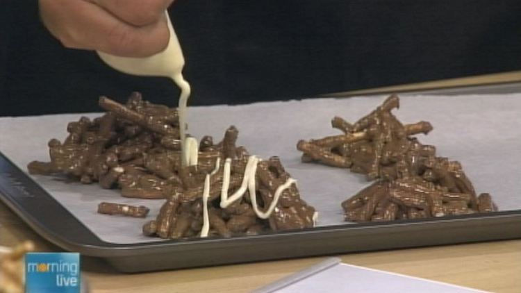 White chocolate being drizzled on chocolate-covered pretzels; Morning Live, August 18, 2014