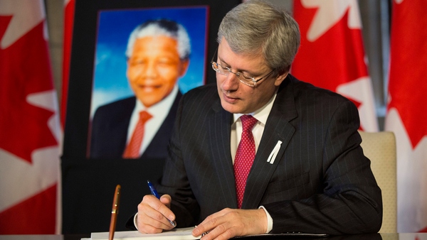 Prime minister Stephen Harper signs book of condolences for Nelson Mandela, December 6, 2013 (PMO photo)