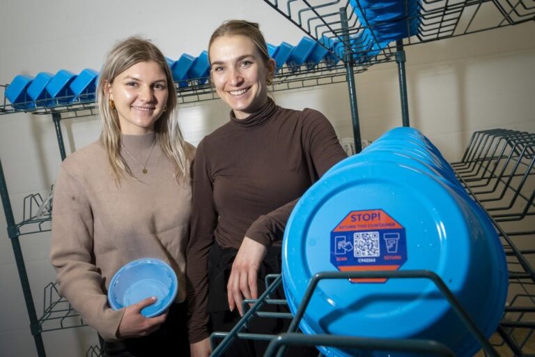 Friendlier co-founders, Kayli Dale, 25, left and Jacquie Hutchings, 26, right, with some of their re-usable food packaging containers fresh from being washed and sterilized at their facility in Guelph, Ont. on Monday, March 20, 2023.